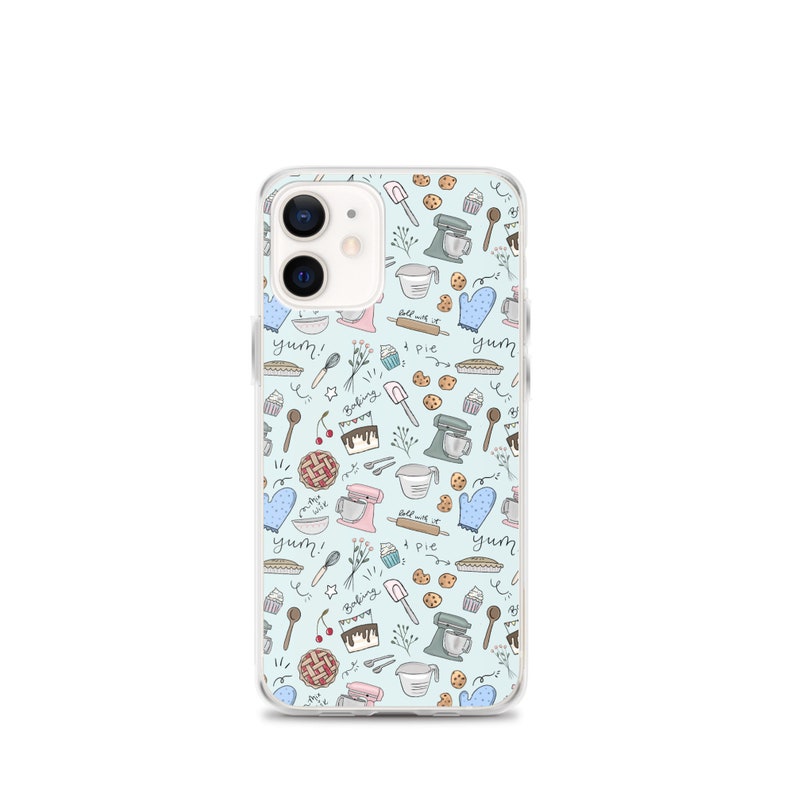 May include: A clear phone case with a light blue background and a pattern of baking-themed illustrations. The illustrations include a mixer, a pie, a cupcake, a whisk, a rolling pin, a spoon, a measuring cup, a cookie, a cherry, a cake, and the words "yum!" and "baking".