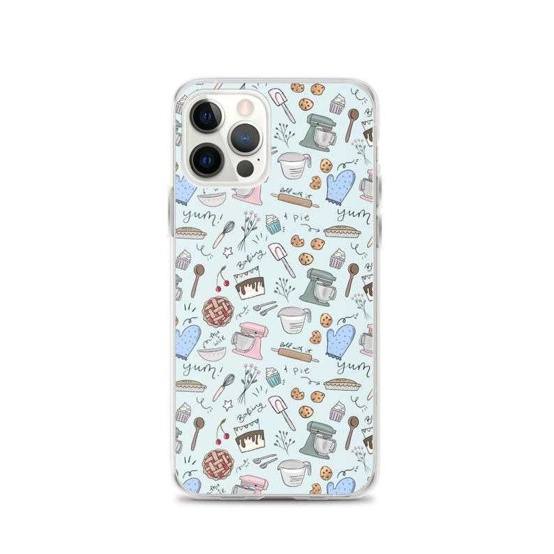 May include: A clear phone case with a light blue background and a pattern of various baking-themed illustrations. The illustrations include a mixer, a rolling pin, a pie, a cupcake, a cherry, a spoon, a whisk, a cookie, and the words "yum!" and "baking".