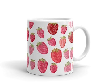May include: White ceramic mug with a pattern of pink and red strawberries. The mug has a white handle.