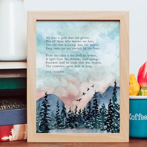 May include: A framed print with a watercolor painting of a forest scene with a quote from J.R.R. Tolkien: "All that is gold does not glitter, Not all those who wander are lost; The old that is strong does not wither, Deep roots are not reached by the frost. From the ashes a fire shall be woken, A light from the shadows shall spring; Renewed shall be blade that was broken, The crownless again shall be king."