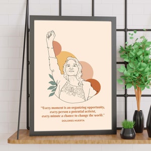 May include: A black and white line drawing of Dolores Huerta with her fist raised in the air. The background is a peach color with abstract shapes in orange, yellow, and brown. The quote "Every moment is an organizing opportunity, every person a potential activist, every minute a chance to change the world." is printed below the image, with "DOLORES HUERTA" printed below the quote.
