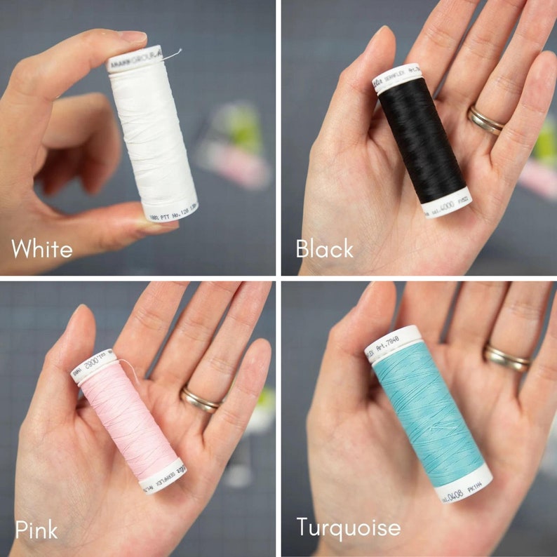May include: Four spools of thread in different colors: white, black, pink, and turquoise. Each spool is held in a hand.