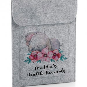 May include: Grey felt envelope featuring a cute cartoon elephant and pink flowers. The text "freddie's Health Records" is printed on the front.
