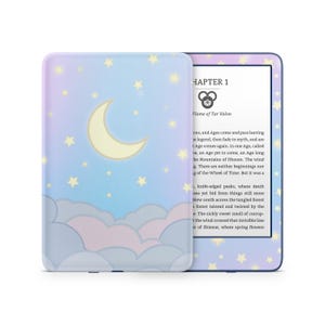 May include: A blue and purple e-reader with a starry night sky background and a crescent moon. The screen displays the text "Chapter 1 Flame of Tar Valon".