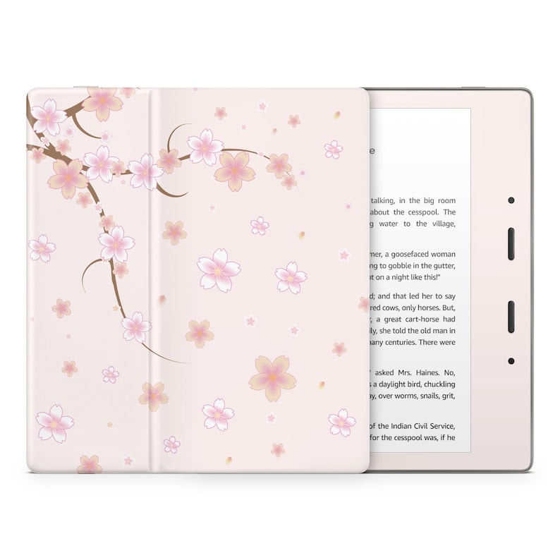 May include: A pink and white e-reader case with a floral design. The case features a cherry blossom pattern with pink flowers and brown branches. The e-reader is open to a page of text.