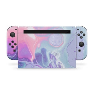 May include: A pink and blue marbled Nintendo Switch console with a black screen and black buttons. The console is in a closed position.