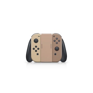 Pu&ograve; includere: Un controller Nintendo Switch Joy-Con beige e marrone con pulsanti neri e un'impugnatura nera.