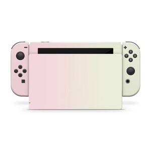 May include: A pink and green ombre Nintendo Switch console with black buttons and a black screen.