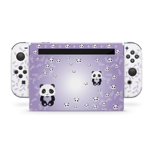 May include: A purple and white Nintendo Switch console skin with a panda bear design. The skin features a repeating pattern of panda bears and paw prints.