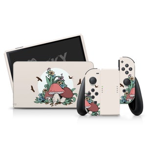 May include: A beige Nintendo Switch console and two controllers with a mushroom and floral design. The design features red and pink mushrooms, green leaves, and blue flowers.