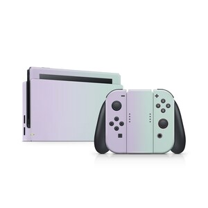 May include: A purple and green ombre Nintendo Switch console with matching Joy-Con controllers. The console is closed and the controllers are detached.