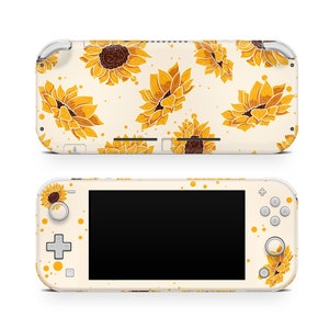 May include: A white Nintendo Switch Lite console with a custom skin featuring a yellow and brown sunflower pattern. The console has a black screen and white buttons.