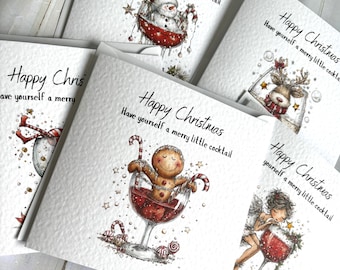 May include: A collection of square white greeting cards featuring festive watercolour illustrations of characters in cocktail glasses. Each card displays the text Happy Christmas Have yourself a merry little cocktail with images of a snowman, reindeer, gingerbread person, and an angel.