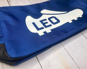 May include: Blue shoe bag with a white outline of a shoe and the name "LEO" printed on it.