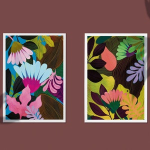 Two spring and summer floral tropical art prints, both art prints are very colorful with bright blue flowers in the middle, and the other artwork has bright green tropical leaves surrounding it.