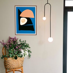 A modern minimalist poster with organic shapes geometric Scandinavian art print, it has the bright vivid color of blue pink, and black. The art print is made by an artist named Kalamasa Art Gallery. A large Wall Art.