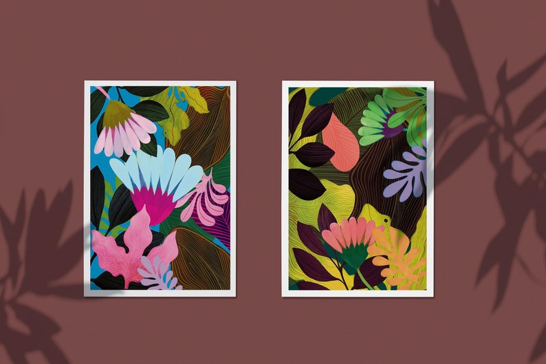 Two spring and summer floral tropical art prints, both art prints are very colorful with bright blue flowers in the middle, and the other artwork has bright green tropical leaves surrounding it.