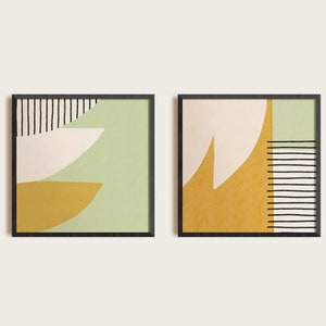 May include: Two framed abstract art prints with geometric shapes in shades of green, yellow, and white. The prints have black lines and are framed in black.
