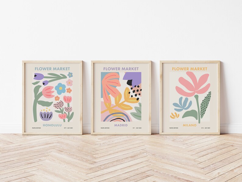 May include: Three framed prints with the title "Flower Market" and the city names Honolulu, Madrid, and Milano. Each print features a colorful abstract floral design.