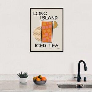 May include: A retro-style poster with a black frame featuring a stylized illustration of a glass of iced tea with a lime wedge. The text "LONG ISLAND ICED TEA 1920" is printed in black on a beige background.