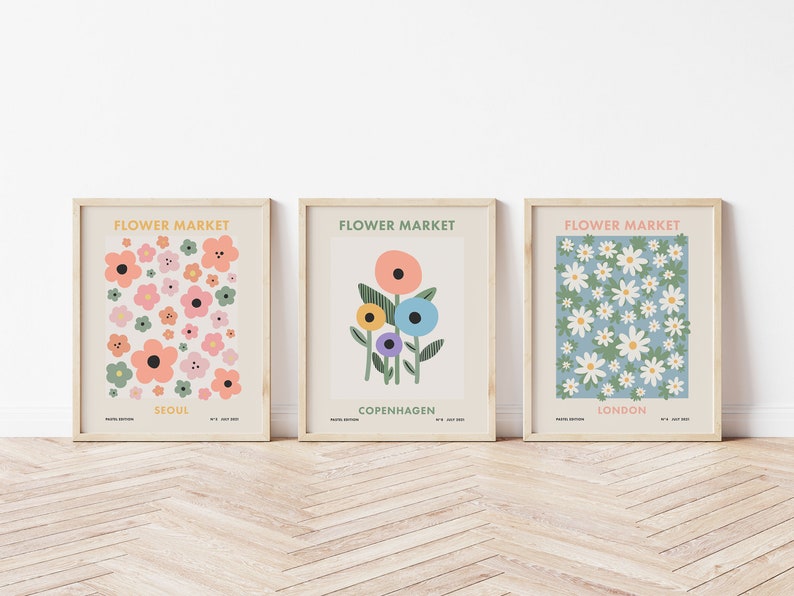 May include: Three framed prints with the title "Flower Market" and the city names "Seoul", "Copenhagen", and "London". Each print features a different floral design in a colorful, abstract style.