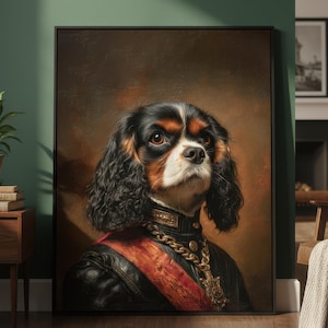 May include: A framed portrait of a Cavalier King Charles Spaniel, dressed in regal attire. The dog has black, white, and brown fur, with a gold chain and red sash. The background is a dark, vintage-style painting.