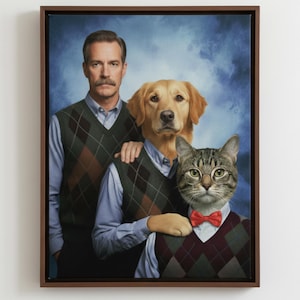 May include: A framed portrait featuring a man with a moustache, a golden retriever, and a tabby cat. All three subjects wear light blue collared shirts under dark argyle sweater vests. The cat wears round glasses and a red bow tie against a blue background.