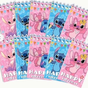 May include: A collection of spiral-bound notebooks featuring the characters Stitch and Angel from Lilo & Stitch. The notebooks have pink and blue backgrounds with the words "Happy Birthday" printed on them. The notebooks are decorated with colorful bunting.