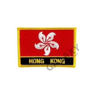 May include: A rectangular patch featuring the Hong Kong flag. The patch has a red background with a white Bauhinia flower in the center. The words "HONG KONG" are displayed in white text on a black banner at the bottom, with a gold border.