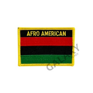 May include: A yellow-bordered patch with the words "Afro American" in yellow thread. The patch features three horizontal stripes: red, black, and green.