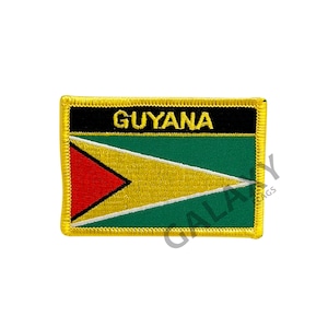 May include: A yellow, green, red, and black embroidered patch with the word "GUYANA" in black lettering. The patch is surrounded by a yellow border.