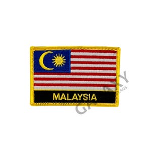 May include: A yellow embroidered patch with the Malaysian flag and the word "MALAYSIA" in black lettering.