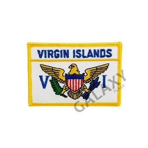 May include: A yellow embroidered patch with the words "Virgin Islands" in blue lettering. The patch features a white background with a yellow eagle holding a blue shield with red and white stripes. The eagle is holding a green branch in its left talon and a blue spear in its right talon.