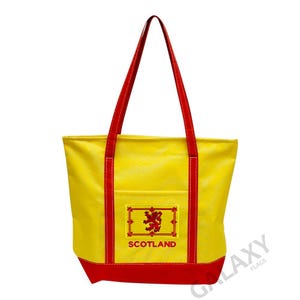 May include: Yellow tote bag with red trim and a pocket featuring the Scottish flag and the word "SCOTLAND".