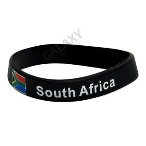 May include: Black silicone bracelet with the South African flag and the text "South Africa" printed in white.