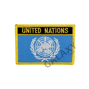 May include: A blue and white embroidered patch with the words "UNITED NATIONS" in black lettering. The patch has a gold border.