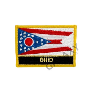 May include: An embroidered patch featuring the Ohio state flag. The flag is a blue and red tri-color with a white star-filled pennant in the upper left corner. The pennant has a red circle in the center. The patch has a black border with the word "OHIO" in gold lettering.