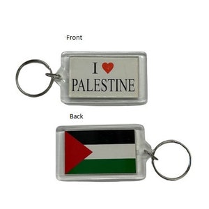 May include: A clear plastic keychain with a red heart and the text "I love Palestine" on the front and the Palestinian flag on the back.