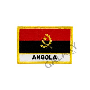 May include: An embroidered patch featuring the flag of Angola. The patch is rectangular with a yellow border and a white background. The Angolan flag is red, black, and yellow with a symbol of a machete and a gear in the center. The words "ANGOLA" are printed in black below the flag.