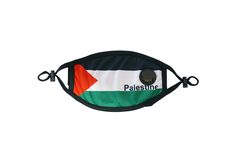 May include: A black face mask with a valve, featuring the Palestinian flag and the word "Palestine" printed on it.