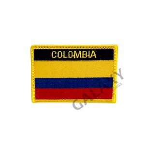 May include: A yellow, black, blue, and red embroidered patch with the word "COLOMBIA" in gold lettering.