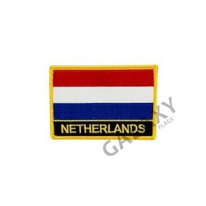 May include: A rectangular embroidered patch with the Dutch flag, red, white, and blue, with a gold border. The text "NETHERLANDS" is in gold letters on a black background.
