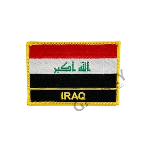 May include: An embroidered patch featuring the flag of Iraq. The patch is black, white, red, and green with the Arabic text "Allahu Akbar" in green. The patch has a yellow border and the word "IRAQ" in yellow text.