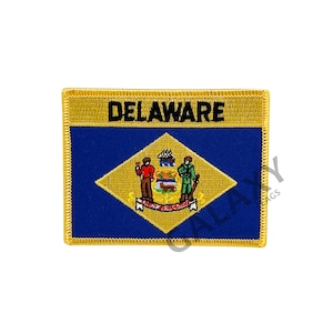May include: Embroidered patch featuring the state flag of Delaware. The patch is blue with a yellow diamond in the center. The diamond contains the state seal, which depicts a farmer and a soldier standing on either side of a plow. The patch has a gold border and the word "DELAWARE" is written in black at the top.