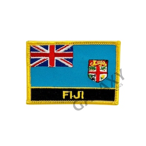 May include: A blue and red embroidered patch with the Fijian flag and the word "FIJI" in black lettering. The patch has a gold border.