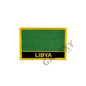 May include: An embroidered patch in green and black with a yellow border. The patch features the word "LIBYA" in yellow lettering.