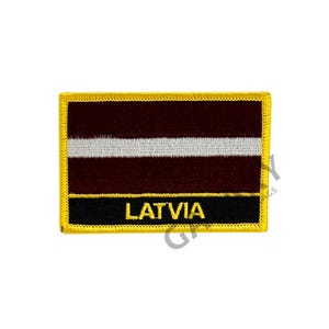 May include: Embroidered patch featuring the flag of Latvia. The rectangular patch has a maroon background with a white stripe across the center. The bottom section is black with the word "LATVIA" in yellow.