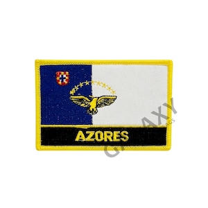 May include: A yellow embroidered patch with the flag of the Azores. The flag features a blue field with a white shield and a white field with a yellow bird. The text "AZORES" is embroidered in yellow on a black background.