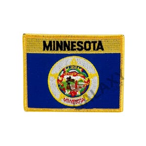 May include: A blue and white embroidered patch with the state seal of Minnesota and the word "MINNESOTA" in black lettering. The patch has a gold border.