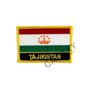 May include: An embroidered patch featuring the flag of Tajikistan. The patch is red, white and green with a gold border. The centre of the patch features a crown and stars, and the word "TAJIKISTAN" is written in gold letters on a black background.